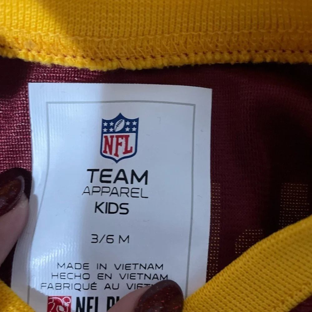 NFL Team Apparel Kids Maroon and Yellow Onesie